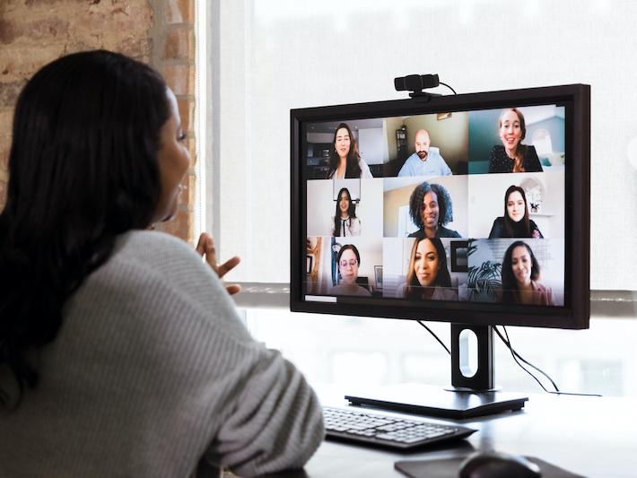 A woman communicates with classmates in a synchronous remote classroom