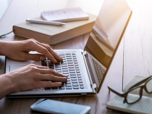 woman typing on laptop