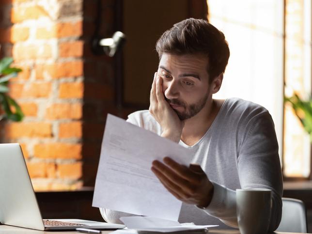 Man reading rejection letter