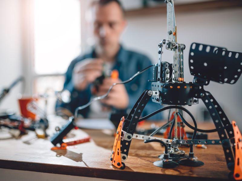 A man building a machine on his desk