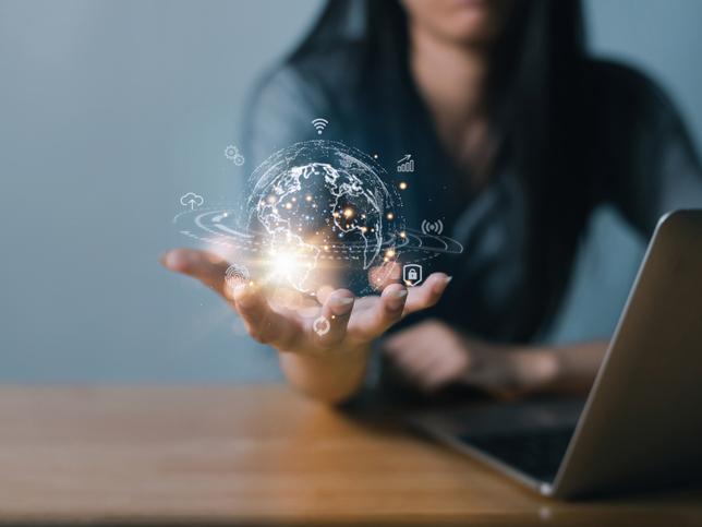 Young woman holding digital impression of globe