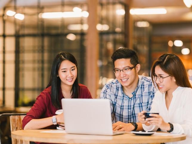 Asian students working at a laptop