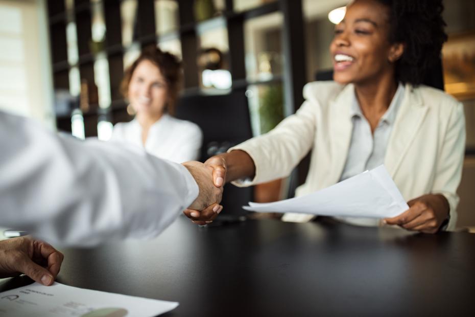 Two women welcoming a candidate to an interview