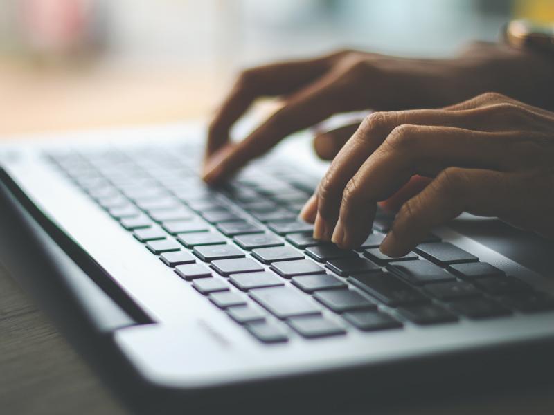 Person typing on laptop