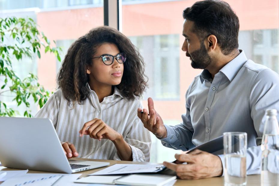 Young female student talks to an older coach or mentor