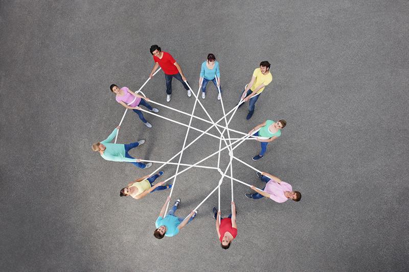 Group of people tangled in string