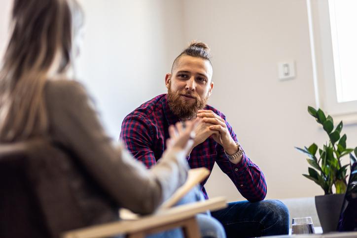 woman talking to young man