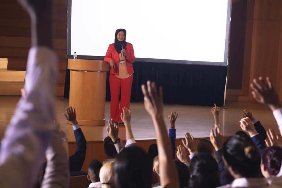 Researcher standing at a podium giving a speech