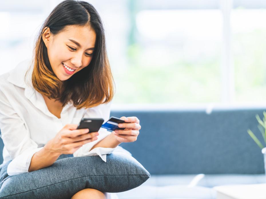 Student paying for something online using her debit card