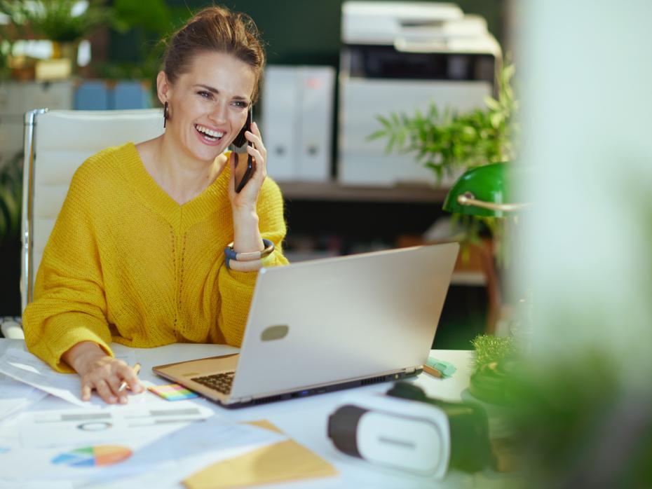 Female accountant sitting at her desk making a phone call