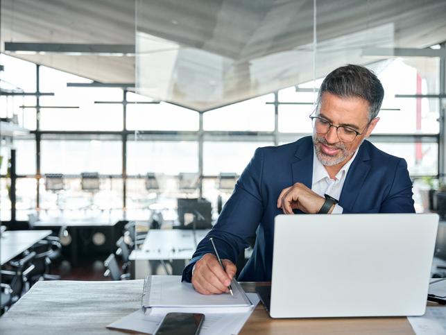 A businessman works at a laptop