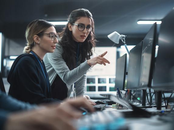 Two young women working on cybersecurity