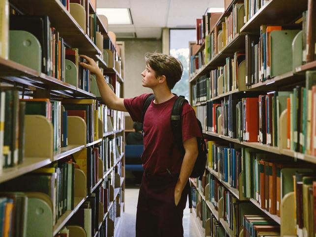 Student in library stacks