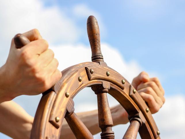 Hands on a ship's wheel