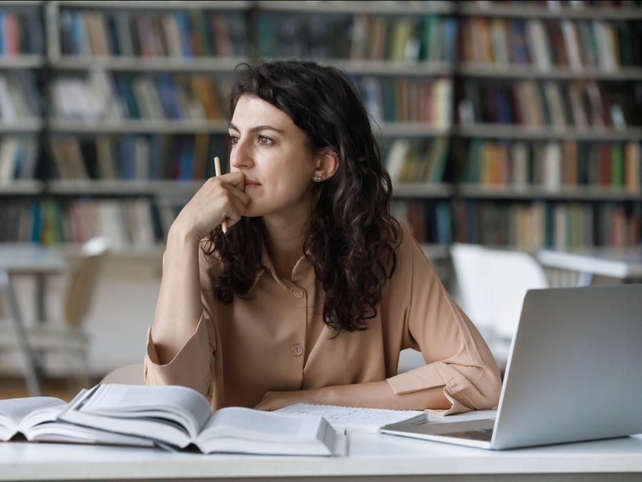 Student thinking at her desk