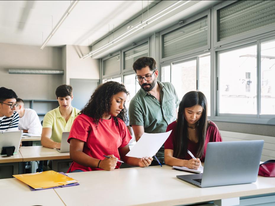 Students in a classroom on their laptops 