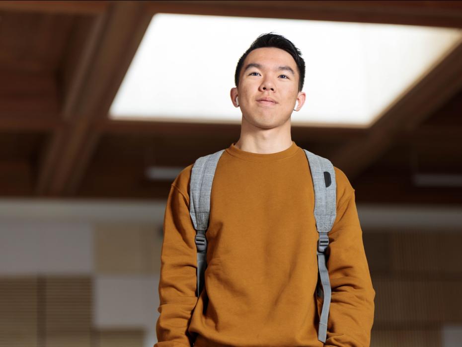 Student standing outside a campus building