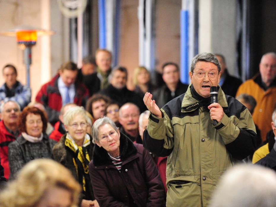 Man speaking at a community meeting