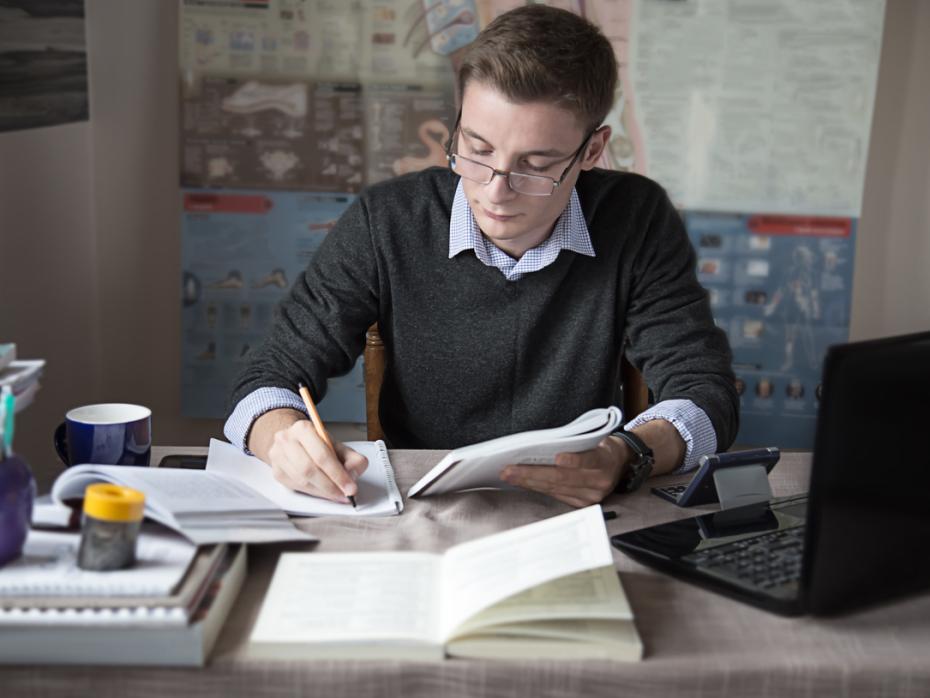 PhD student studying at his desk