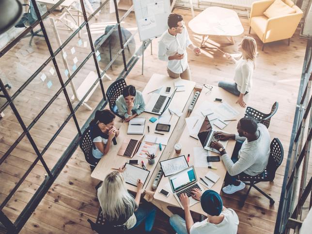 A group of people working round an office table