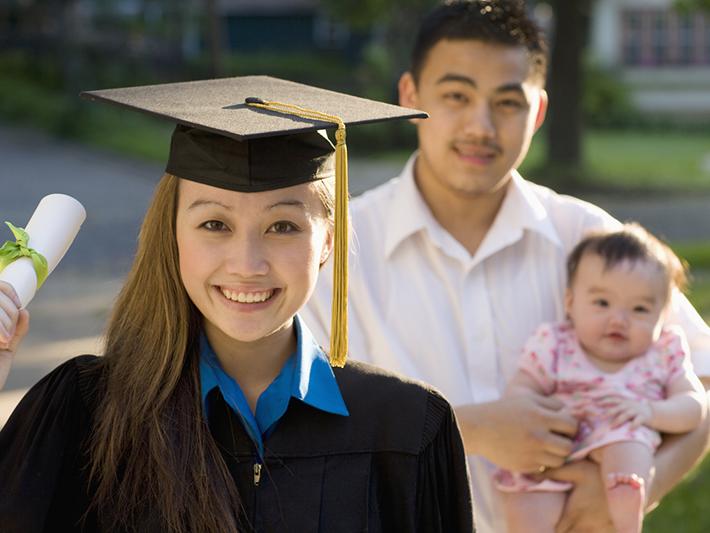 Young Asian female graduate with baby and partner