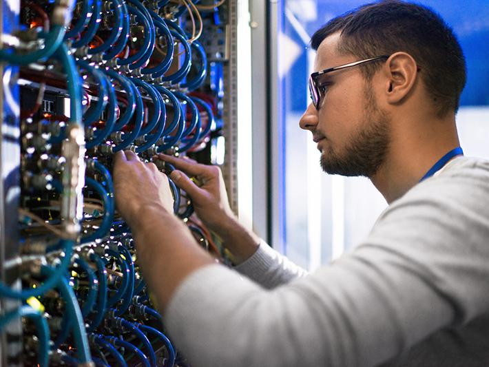 computer technician working on mainframe