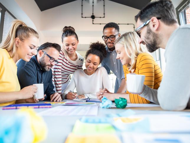 A group of people work round a table