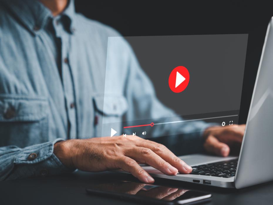 Man looking at Youtube on a laptop