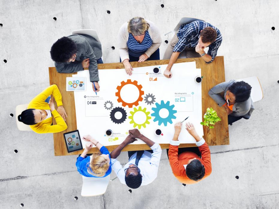 Group of people sitting around a table at a meeting