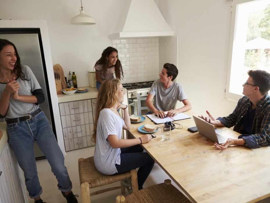 Students in a kitchen having breakfast together