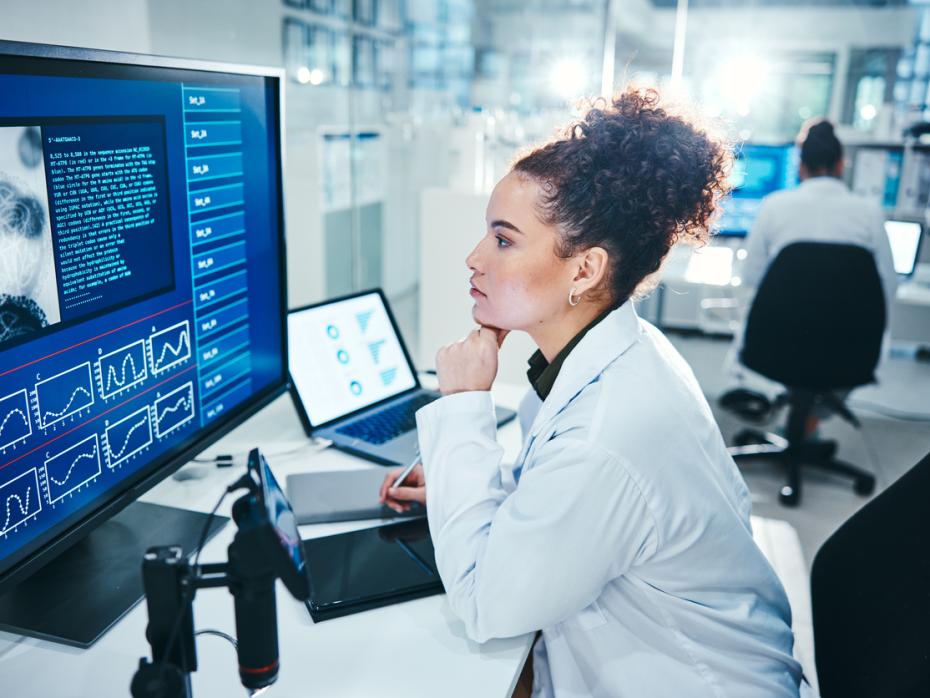 A researcher in a lab looking at her computer