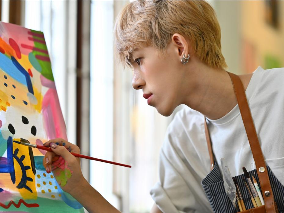 A student painting on a canvas