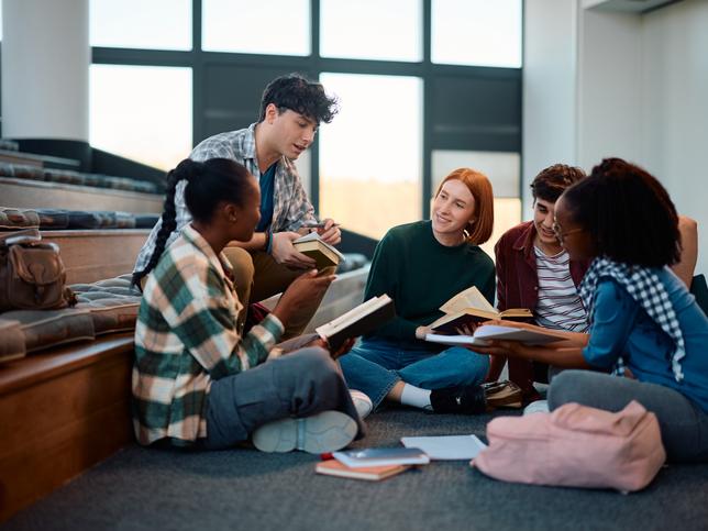 Students chat in a lecture hall