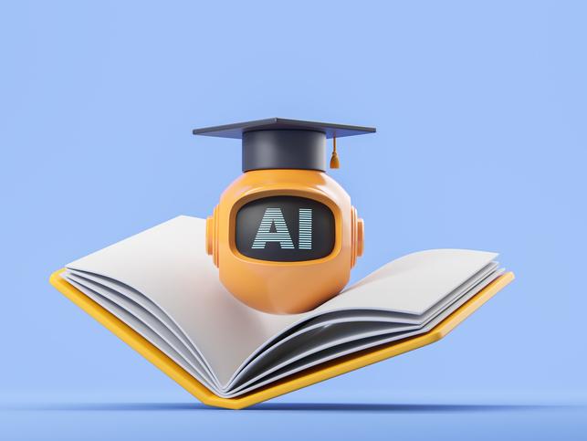 A robot wears a mortarboard and rests upon an open book