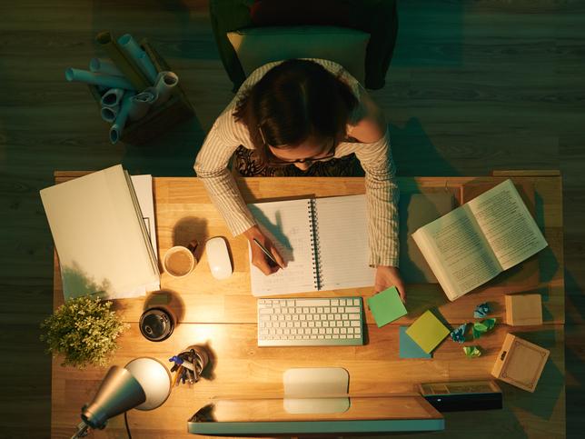 A woman working at a desk, viewed from above