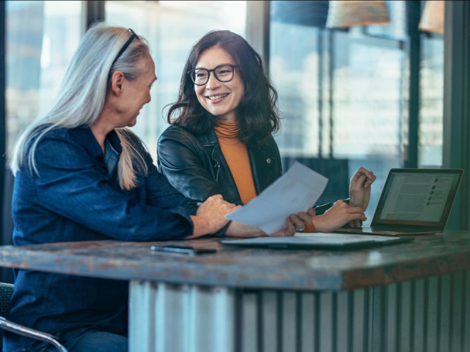 Older woman mentoring young Asian female university student