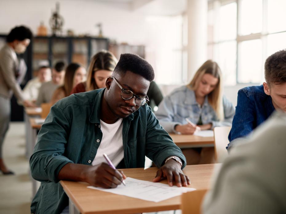 Students in an exam hall being assessed