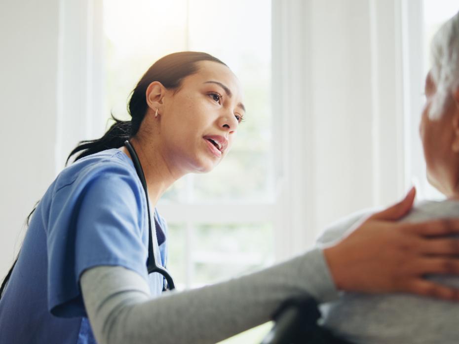 Medical professional talking to a female patient