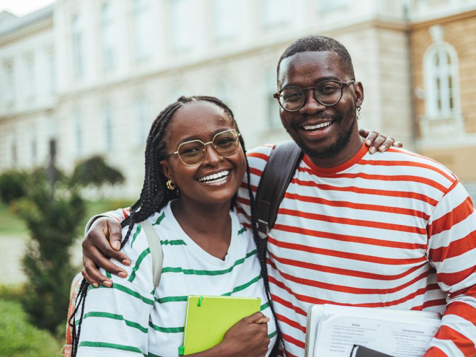 Two students smiling to camera