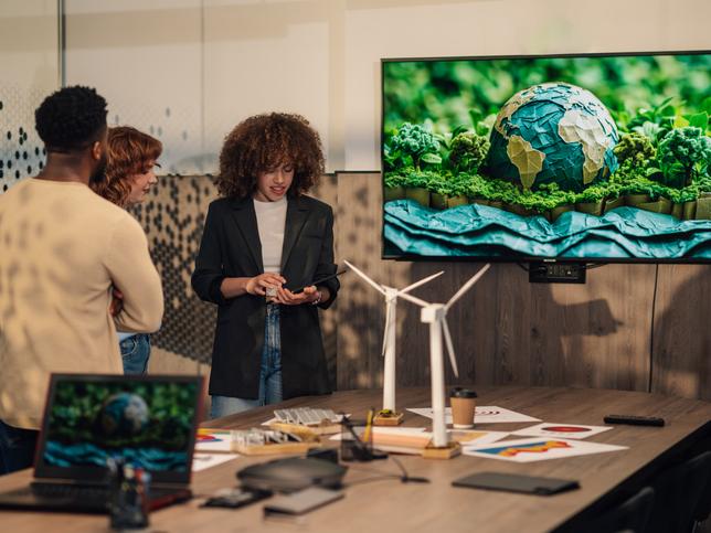 A presentation takes place on a screen featuring an illustration of the Earth