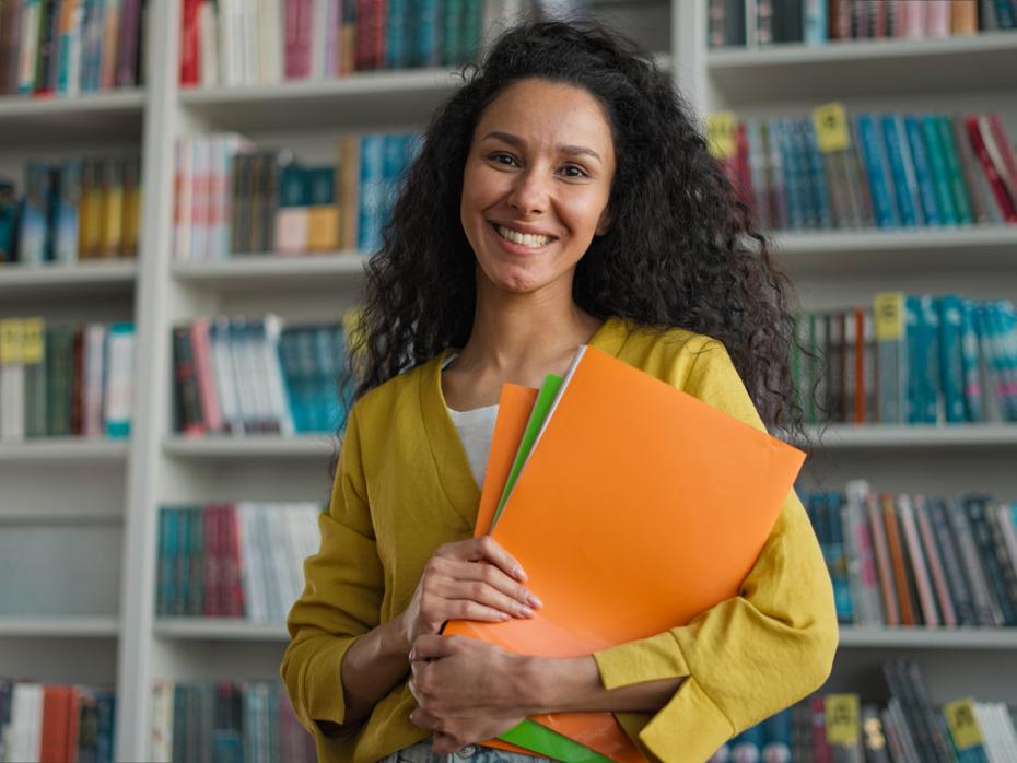 A female academic smiling to camera