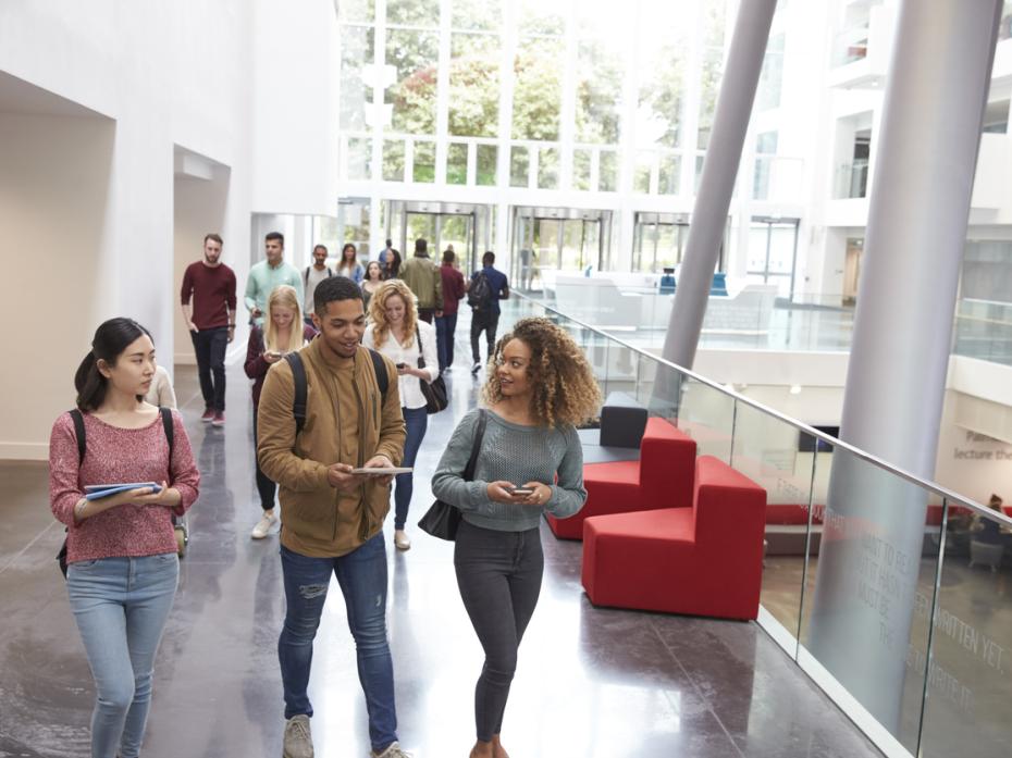 Students walking through campus building