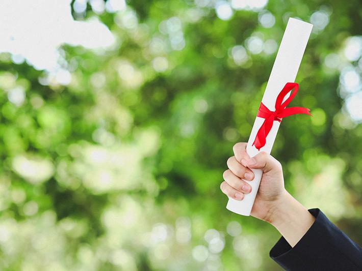 Hand holding university diploma