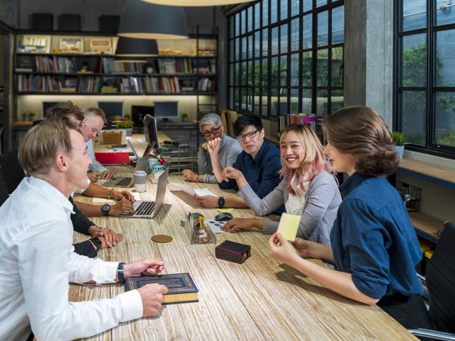 A group of students work round a table