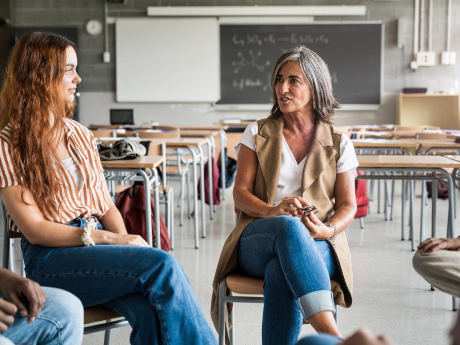 A teacher speaking to a student