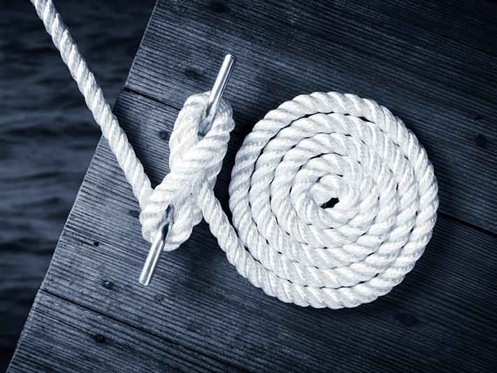 Rope tying boat to dock