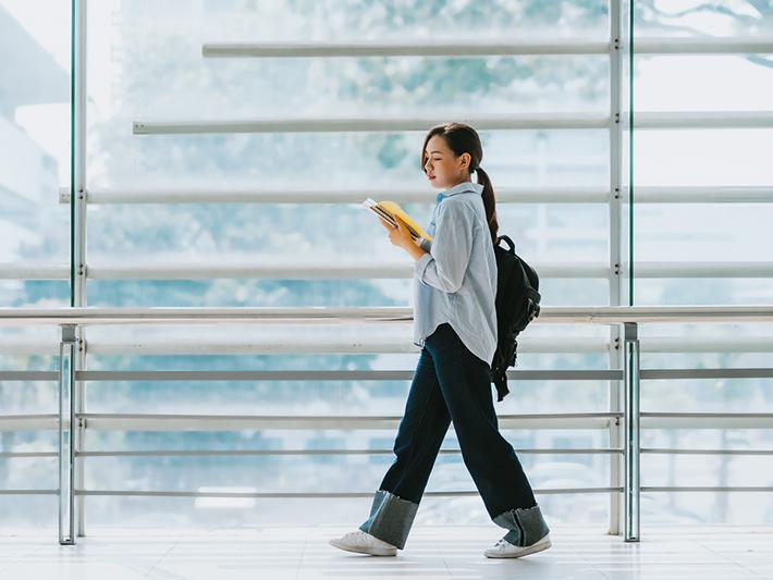 Female university student walking to class