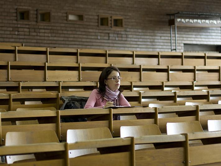 Female students sitting along in lecture hall