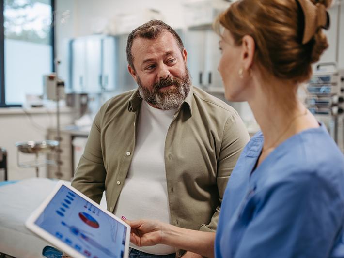 Middle-aged male patient with female doctor