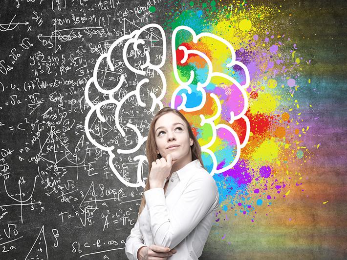 Young woman in front of brain illustration, arts and sciences